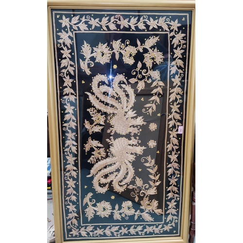 751 - A central Asian foil thread embroidered panel depicting mythical birds, 62 x 114cm, framed