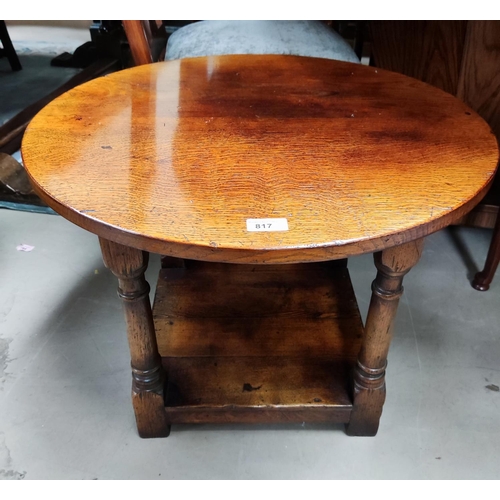 817 - A distressed oak 2 tier coffee table with circular top in the manner of Titchmarsh & Goodwin; a ... 