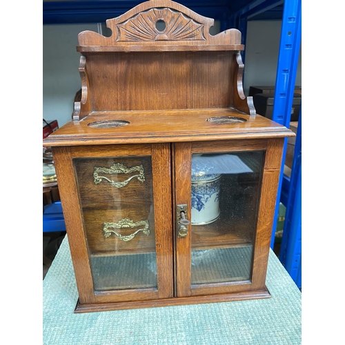 36A - Late 19th/early 20th century smoking cabinet with tobacco jar, glazed doors and pipe rack above