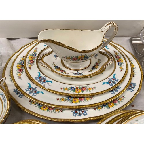 562 - A Paragon 'Ontario' dinner service with 2 large and 1 small tureen, graduating meat plates, gravy et... 