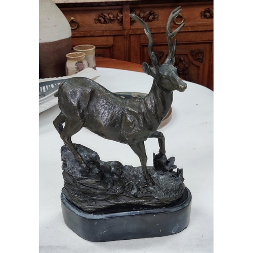 778 - A bronze of a stag on rocky outcropping mounted on slate base height 26cm