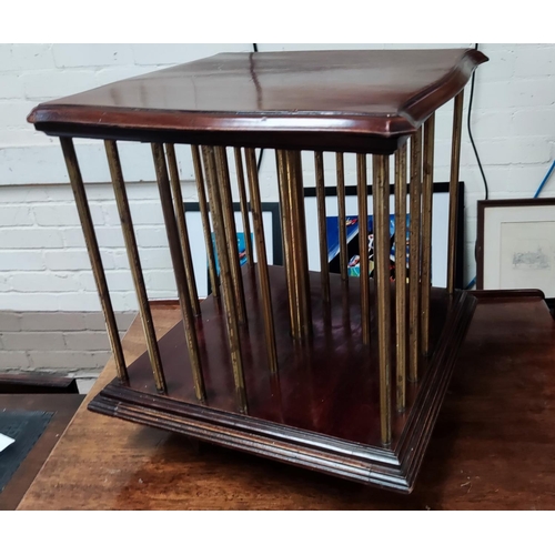 794 - An early 20th century mahogany and brass table top revolving bookcase with Patent Office Designs Bra... 