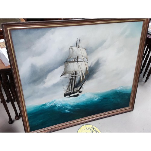 740A - A large 20th century oil on canvas painting of a two masted ship on rolling waves 75 x 89cm