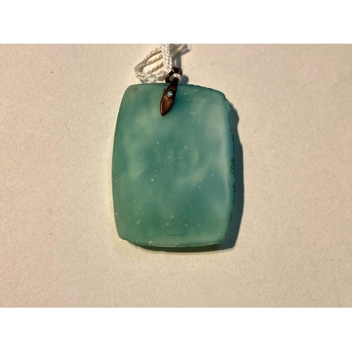 622 - A turquoise jade coloured rectangular pendant in the Chinese manner, with relief decoration of flowe... 