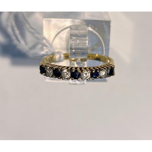 700E - A 9ct gold ring set with clear and dark blue stones 1.4gms