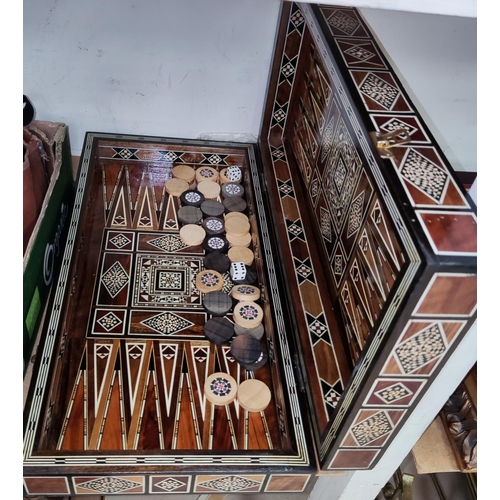 122 - A Caro-ware geometric inlaid backgammon box with playing pieces