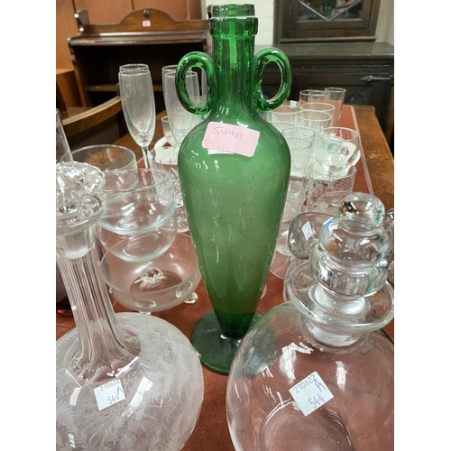 544A - An unusual green glass vase with double handles and tapering shape; two etched decanters and another... 