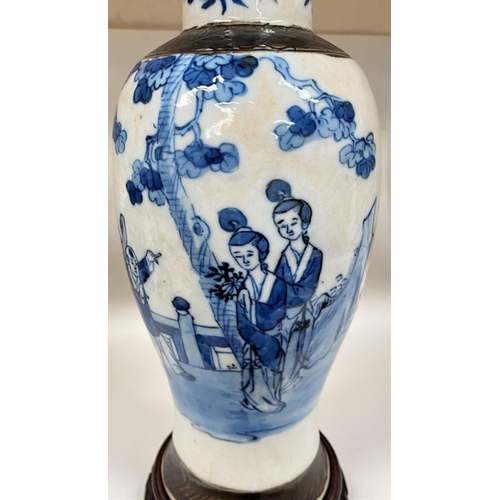 545A - A late 19th/early 20th century Chinese blue and white crackle glaze baluster vase with brown bark ef... 