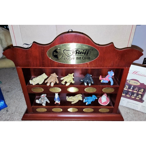 275 - A Steiff wooden stand with miniature metal teddy bears