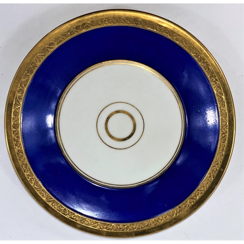 519 - A late KPM cabinet cup and saucer in blue and gilt with figural handle and panels, polychrome panel ... 