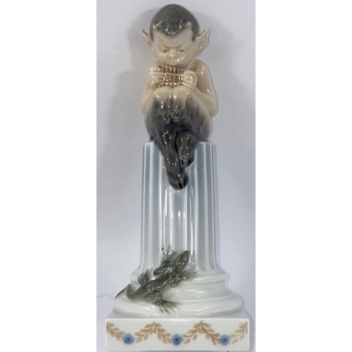 541 - A Royal Copenhagen group depicting a fawn with panpipes seated on a classical column, circa 1958, he... 