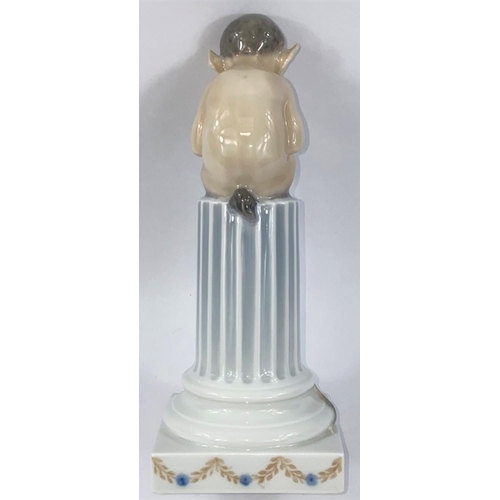 541 - A Royal Copenhagen group depicting a fawn with panpipes seated on a classical column, circa 1958, he... 