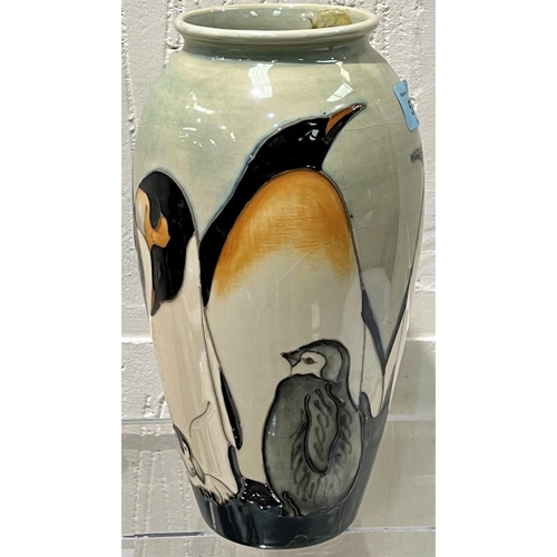 571 - A modern Moorcroft tapering 'Penguin' vase decorated with penguins and chicks against a celadon grou... 