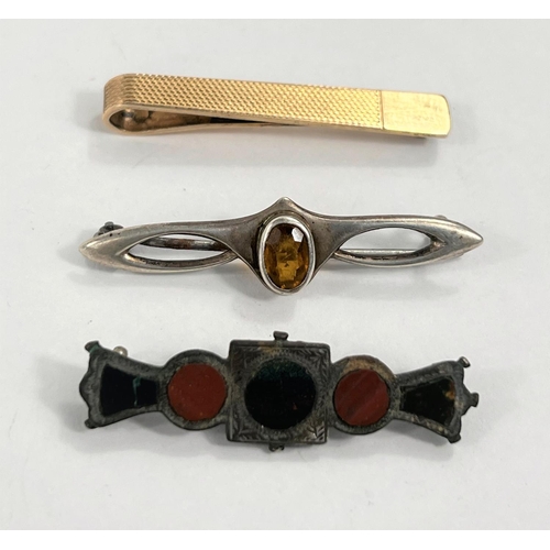 607 - A silver gilt tie clip, an arts and crafts hallmarked silver brooch set with citrine and a stone bro... 