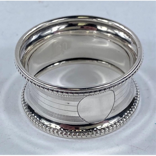 696 - A silver engraved  and pierced napkin ring, Birmingham 1913; 5 other hallmarked rings, 3.4 oz