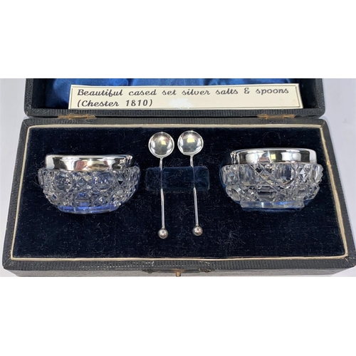 713 - An EPNS sugar basket with blue enamelled liner; a pair of cut glass salts with silver rims, spoons; ... 