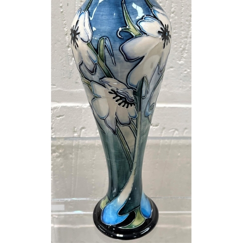 425 - A modern Moorcroft tall slender baluster vase 'Cloths of Heaven' decorated with white flowers agains... 