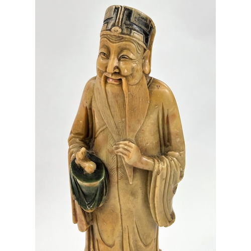 488 - A Chinese carved soap stone carved figure of man on large base, full height 33cm