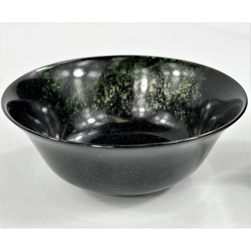 489 - A Chinese carved hardstone bowl dia. 13cm and a Celadon coloured bowl on wooden stand