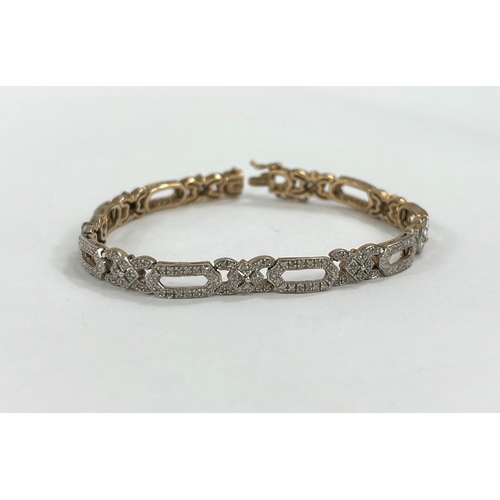 608 - A 9ct gold Art Deco ladies bracelet with diamond set chips, stamped 1 carat in total, stamped on cla... 