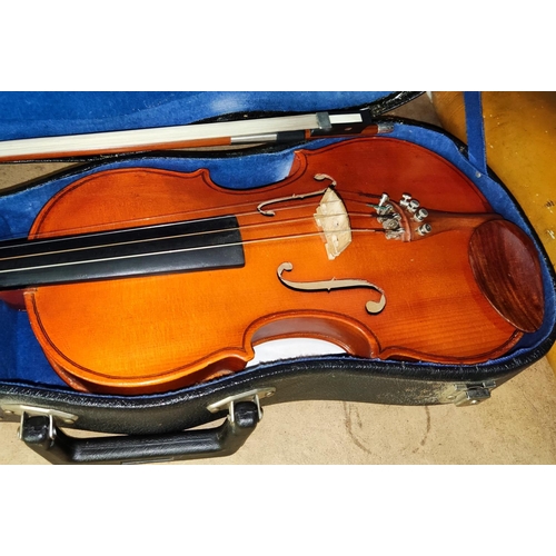 109 - A three quarter size violin with 2 bows, cased, with music and music stand