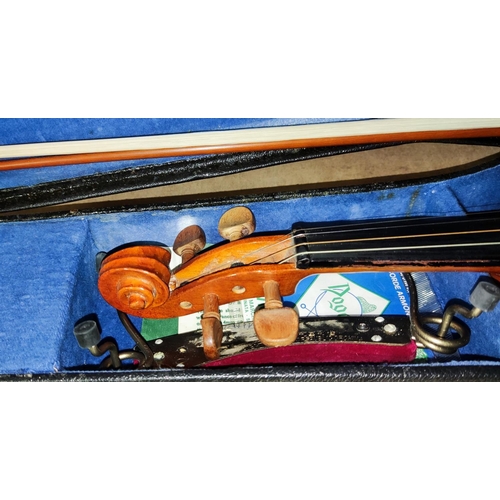 109 - A three quarter size violin with 2 bows, cased, with music and music stand