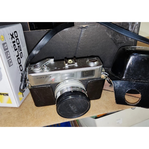 77 - A Minolta SLR Camera; a cine camera; a Coolpix x 5200 digital camera; a selection of decorative bras... 