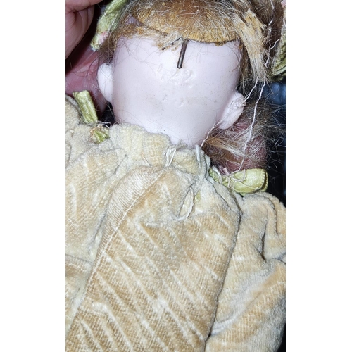 86 - A small bisque head doll with composition body and limbs in Victorian dress