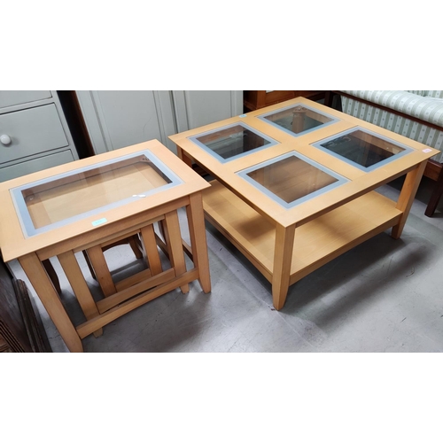 873 - A modern light oak nest of 3 tables with one glass topped and a similar occasional table, the top wi... 