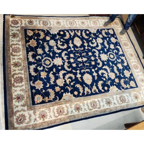 990 - A modern blue ground Persian carpet with multiple border and all over flower head & leaf decorat... 