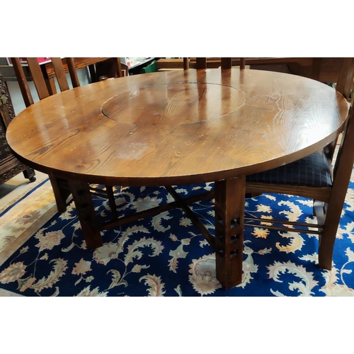 991 - A Charles Rennie Mackintosh style dining suite with circular dining table, with central lazy Suzanne... 