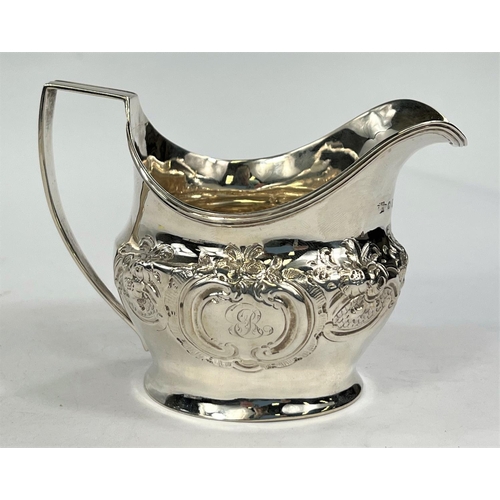 751 - A Georgian hallmarked silver milk jug with embossed floral decoration, London 1806, 3.6oz.