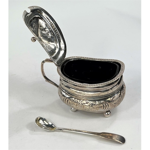 753 - A Georgian hallmarked silver hinged sugar pot with embossed decoration and Bristol blue glass l... 