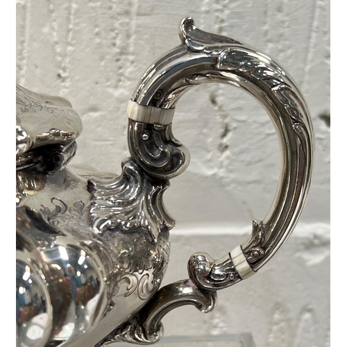 760 - A hallmarked silver teapot with embossed and relief decoration, with acorn finial, leg decoration an... 