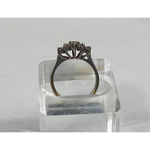 614a - An 18 carat gold dress ring set 9 diamonds in floral arrangement, stones approx. 3mm diameter, 3.9gm