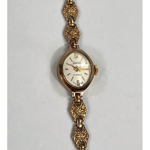 614D - A 9 carat gold lady's Accurist wristwatch with 9 carat gold case and similar floral strap, gross wei... 