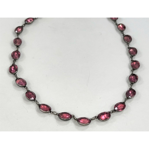 615C - A late Victorian white metal Riviere necklace set with pink facetted stones (last jeweller's receipt... 