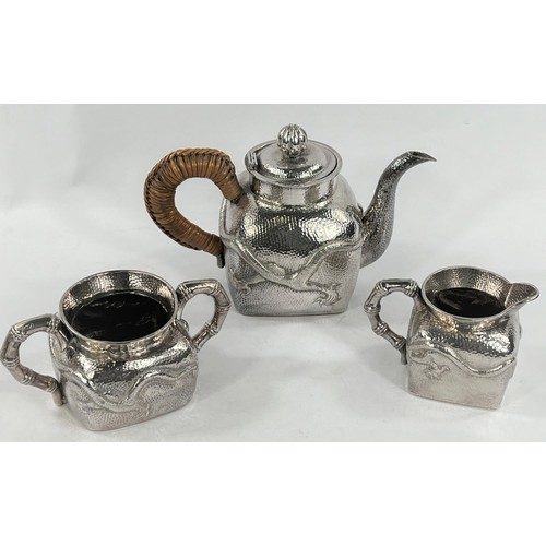 601 - An early - mid Chinese, 3 piece white metal tea set of square form, planished with raised dragon dec... 