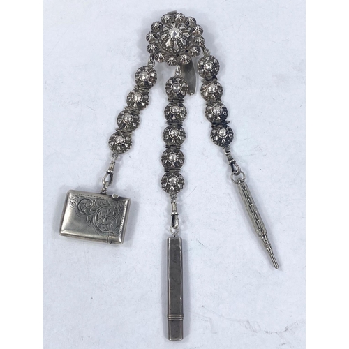 602 - A white metal Chatelaine with three strands, two with hallmarked items