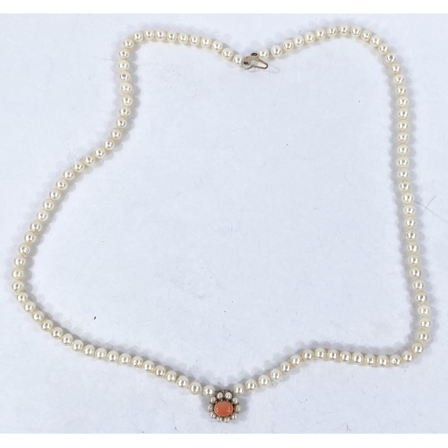 691 - A single strand pearl necklace with 9 carat hallmarked gold clasp set central coral and 10 seed pear... 