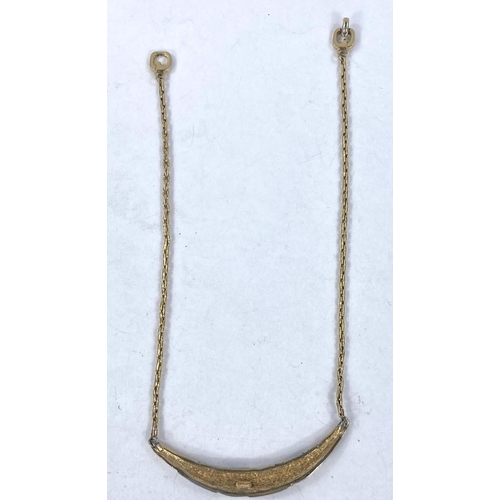 694 - A 2 tone circular metal pendant, stamped '375', 2.3gm; a fine yellow metal chain, stamped '750', 3.1... 