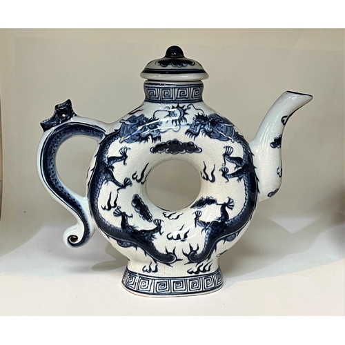 475A - A Chinese blue and white teapot with central hole and 4 character mark to base. HeightA Stone ware b... 