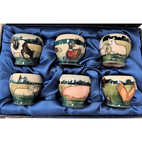 576b - A modern Moorcroft set of 6 small vases decorated with farm animals in landscapes, printed marks, he... 