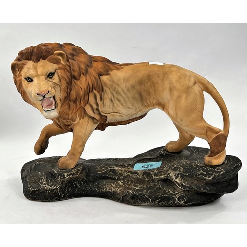 527 - A Beswick bisque lion on rock; a Royal Doulton limited edition group 