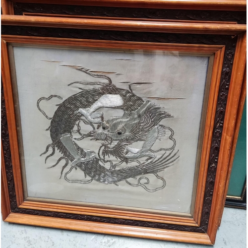 767 - A pair of Chinese dragons in silvered embroidery, 50 x 46cm, framed and glazed