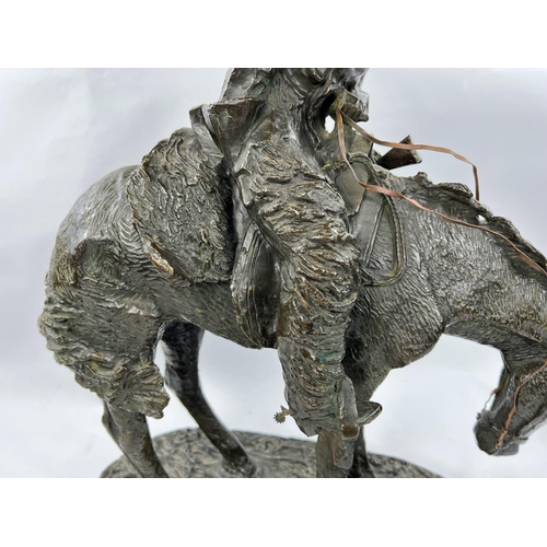 219A - Follower of Fredric Remmington, Cowboy on horse back, bronze, bears signature, marble plinth height ... 