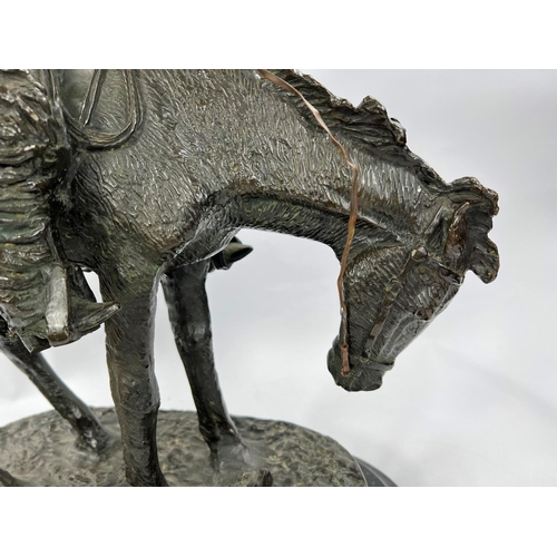 219A - Follower of Fredric Remmington, Cowboy on horse back, bronze, bears signature, marble plinth height ... 