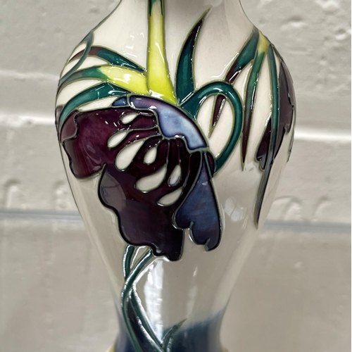 428 - A modern Moorcroft slender baluster vase 'Perisphore' decorated with purple flowers against a white ... 