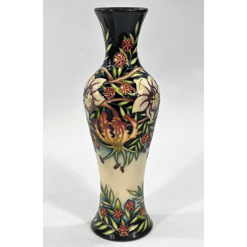 433 - A modern Moorcroft tall slender baluster vase 'Gloriosa Lily' decorated with flowers, leaves and ber... 