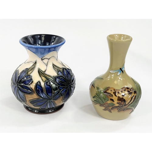 434 - A modern Moorcroft small squat baluster vase decorated with blue flowers on a multicoloured ground, ... 